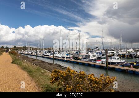 Popular tourist walkway beside Lymington Harbour marina, Lymington, Hampshire, England, UK Stock Photo