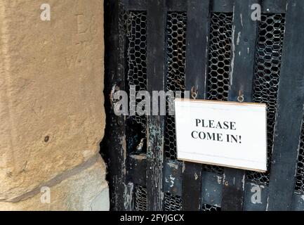 Enter here. Sigh on a village church door in England Stock Photo