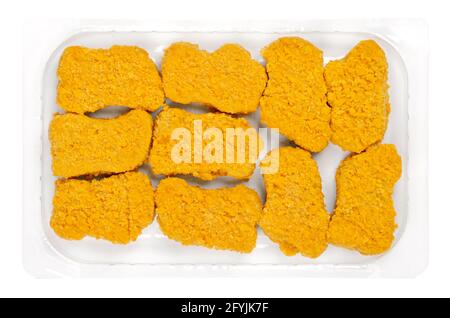 Vegan nuggets, ready to fry in a clear plastic container. Vegan nuggets, based on soy and wheat protein, in crispy breading, pre-fried and cooked. Stock Photo