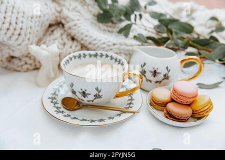 Cup of coffee and plate of macaroons on a table Stock Photo