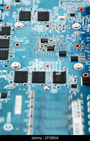 A blue board with chips and a gaming graphics card processor. Progressive cooling system for the video chip, processor and memory. Computer Details Stock Photo
