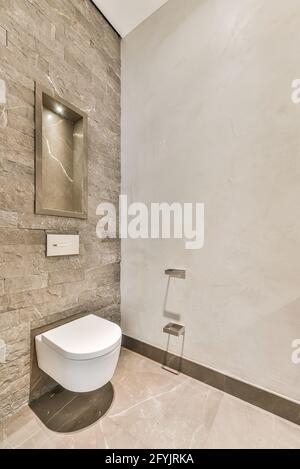 Interior design of small modern restroom with white toilet in corner Stock Photo