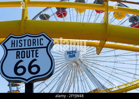 History Route 66 sign with the ferris wheel at Pacific Park in the background in Santa Monica, California, USA Stock Photo