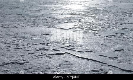 Reflections of sunlight on melt-freeze ice crust. Stock Photo
