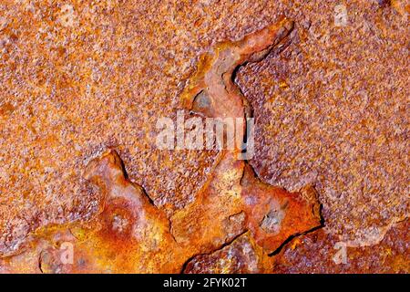 Close up of the pattern of corrosion on the surface of a rusty sheet of metal showing various degrees of oxidation. Stock Photo