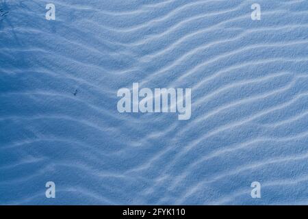 Ripples in the gypsum sand of White Sands National Park, New Mexico.  Blowing wind creates the ripples. Stock Photo