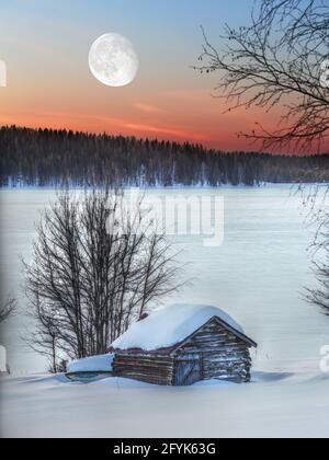 Small wooden shed in dusk with big moon in the sky. Stock Photo