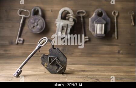 Lock and keys on wooden wall Stock Photo
