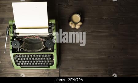 old typewriter with blank paper and coffee Stock Photo