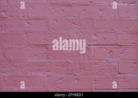 Close up of painted pink brick wall texture background. Stock Photo