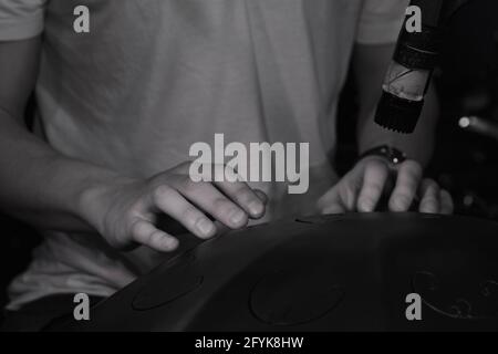 A close-up shot of a drummer playing on a hang, Moscow, Russia Stock Photo