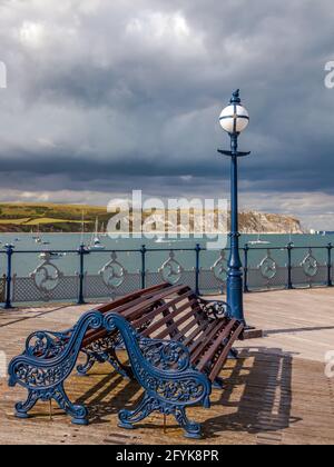 View from the Victorian Swanage pier across the bay with the coastal landmarks of Ballard Down and Old Harry Rocks in the distance. Stock Photo
