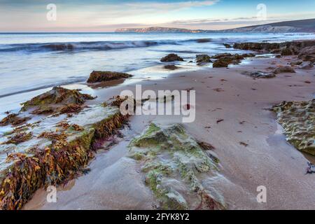 Compton Bay beach on the Isle of Wight, with the cliffs of Tennyson Down in the distance. Stock Photo