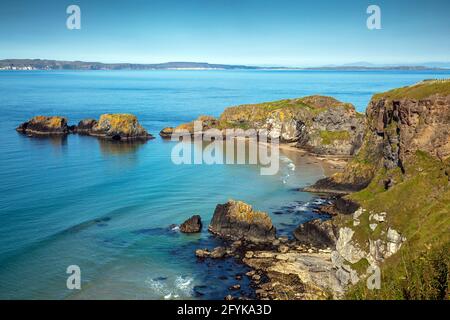 The tiny island of Carrickarede on the Causeway Coast is linked to the mainland by the famous Carrick-a-Rede Rope Bridge. A Game Of Thrones location. Stock Photo