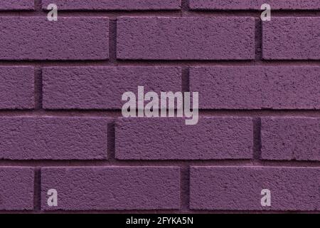 Close up of painted purple brick wall texture background. Stock Photo