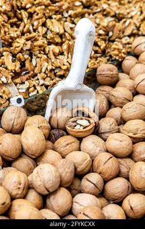 Walnut kernels and whole walnuts are sold at the grocery store Stock Photo
