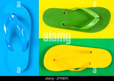 blue, yellow, green rubber flip flops on a multi-colored background Stock Photo