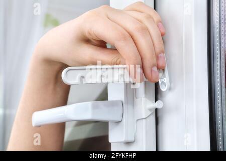 Setting restrictor on double hung window with double-glazed. Stock Photo