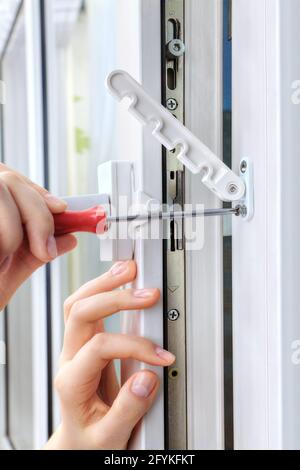 Restrictor is placed on double hung window to restrict expansion. Stock Photo
