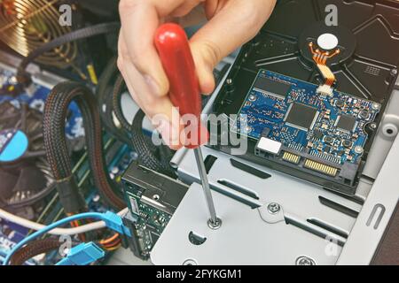 Inside system unit of computer, HDD is fixed with screw. Stock Photo