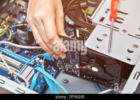 Mounting computer hard drive inside system unit. Stock Photo