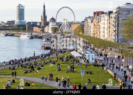 Duesseldorf, Germany. 28th May, 2021. Numerous people walk along 