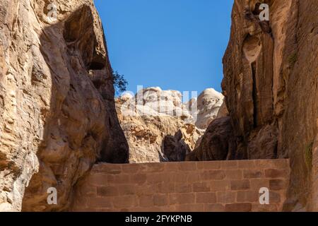 Wall of water collection dam, part of irrigation system built in rock formations, siq, petra, jordan Stock Photo