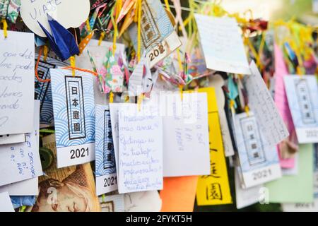 Buenos Aires, Argentina, March 17, 2021: Many strips of paper with wishes written on them, hung in the Japanese garden, following an Asian tradition. Stock Photo