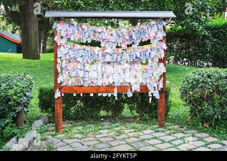 Many strips of paper with wishes written on them, hung in the Japanese garden in Buenos Aires, Argentina, following an Asian tradition. Stock Photo