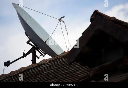 Bucharest, Romania - May 24, 2021: A satellite parabolic dish antenna is mounted on the top of a building in Bucharest. Stock Photo