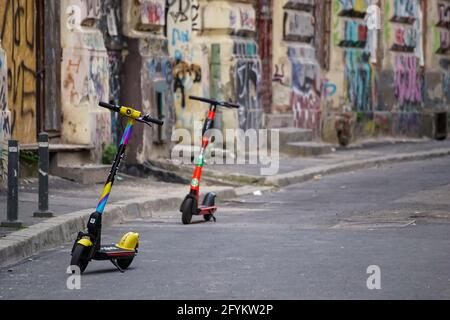 Bucharest, Romania - May 27, 2021: Splash and Lime (rent on Uber) electric scooters are parked on a sidewalk in Bucharest. This image is for editorial Stock Photo