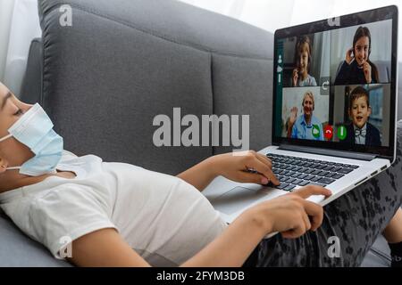 Online remote learning. School kids with computer having video conference chat with teacher and class group. Child studying from home. Homeschooling Stock Photo