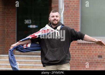 Melbourne, Australia 29 May 2021, A protester wearing an Australian flag during a planned 'Millions March' rally at Flagstaff Gardens, that had been canceled by organisers due to the snap lockdown. Hardcore anti-lockdown and anti-vaccination protesters still attend the park and rallied against the government. Credit: Michael Currie/Alamy Live News Stock Photo