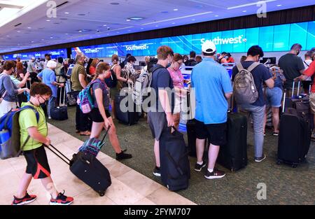 Orlando, United States. 28th May, 2021. Travelers wait in line to check in at the Southwest Airlines ticket counter at Orlando International Airport on the Friday before Memorial Day. As more and more people have received the COVID-19 vaccine, American Automobile Association (AAA) is predicting more than 37 million Americans will travel more than 50 miles this Memorial Day weekend, many for the first time since the pandemic began. (Photo by Paul Hennessy/SOPA Images/Sipa USA) Credit: Sipa USA/Alamy Live News Stock Photo