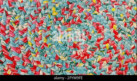 Abstract background vibrant multicolored swirl patterned fabric, closeup off center. Color swatch sample. Stock Photo