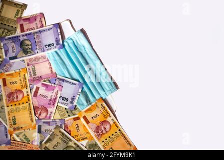 Indian rupee and protective face masks isolated on white background ...