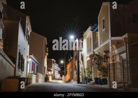 Lit street lights at night in small Greek Assos village located at Kefalonia island, Greece Stock Photo