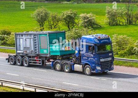 Anderson Haulage Ltd  delivery trucks carrying emergency back-up OAC Atkas Copco generator, lorry, heavy-duty vehicles,transportation, truck, cargo carrier, DAF vehicles, European commercial transport industry HGV, M6 at Manchester, UK Stock Photo