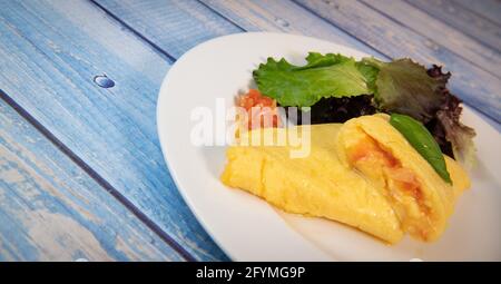 Omelette with salmon and herbs, served on plate, traditional Norwegian dish Stock Photo