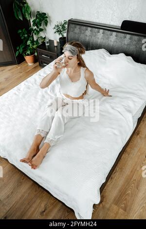 Self care, Mental health, mental wellbeing, calm, mourning routines, start day. No stress, healthy habit, concept. Young woman in pajamas doing Stock Photo