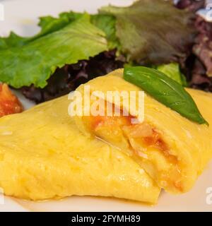 Omelette with salmon and herbs, served on plate, traditional Norwegian dish Stock Photo
