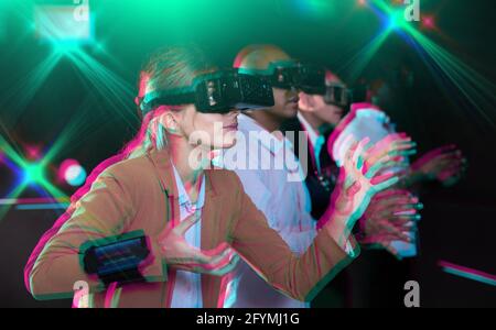 Colleagues playing  video games using virtual reality glasses during  team building Stock Photo