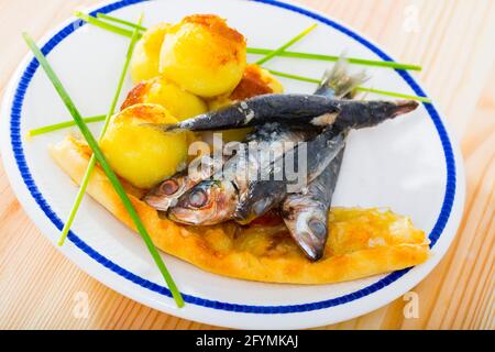 Fried anchovies served with fresh potato croquettes and flatbread Stock Photo