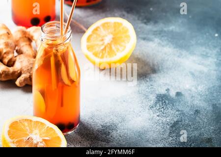 Blueberries, Cranberries Fermented Raw Kombucha Vegan Drink With Ginger And Lemon In Bottle With Eco-friendly Straw Stock Photo