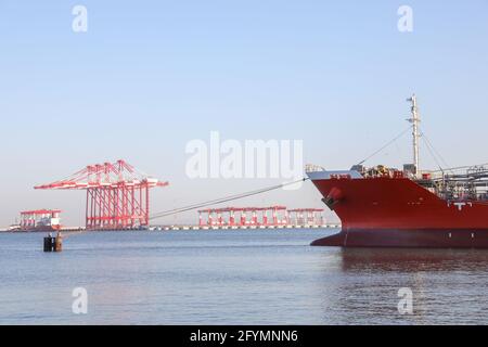 Oil tanker ship loading in port. Fuel tanker ship docked in industrial area. LPG tanker. Stock Photo
