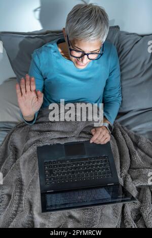 Mature woman making a video call on her laptop Stock Photo