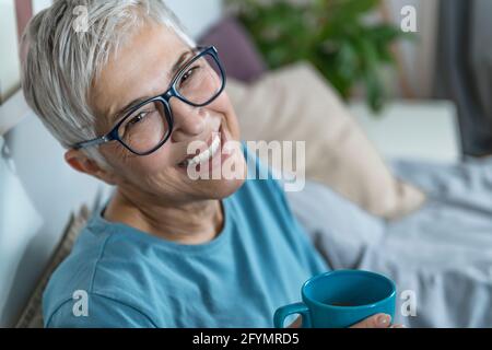 Smiling woman drinking coffee Stock Photo
