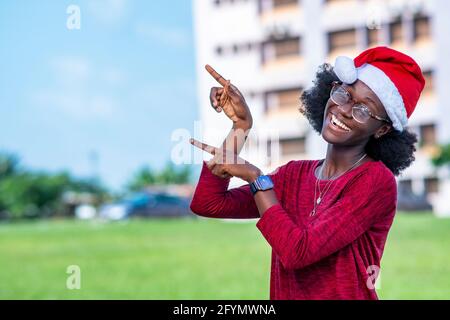 Smiling woman in Santa hat Stock Photo