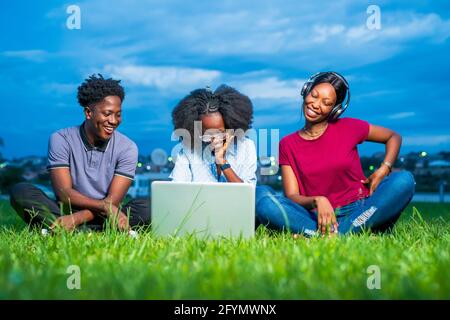 Friends using laptop computer Stock Photo