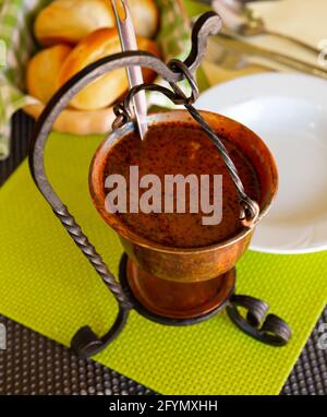 Hearty and spicy Bograc - Slovenian variety of Hungarian goulash cooked from three types of meat and potatoes traditionally served in copper cauldron Stock Photo